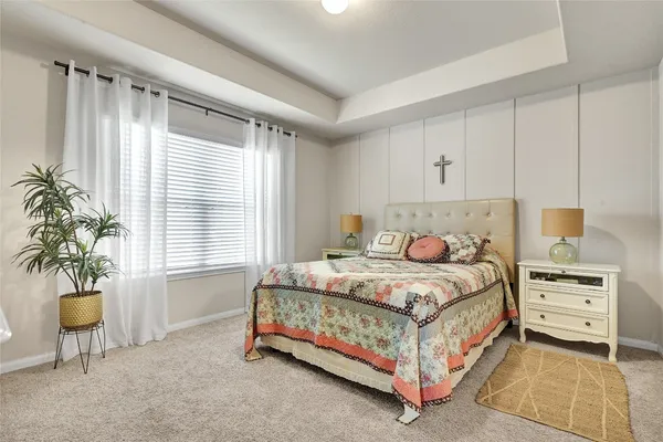 a bedroom with a bed a table and chair