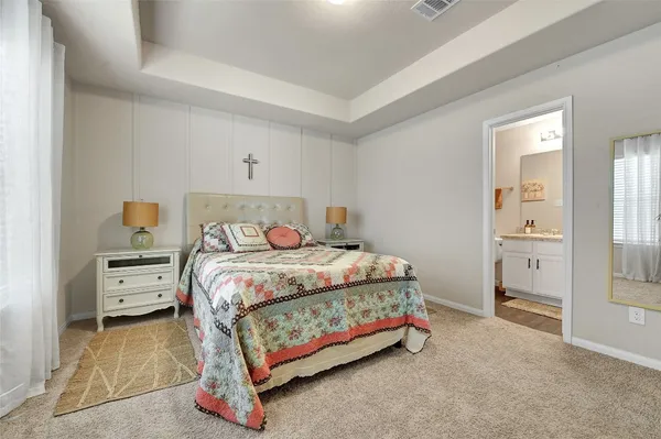 a bedroom with a bed and a night stand