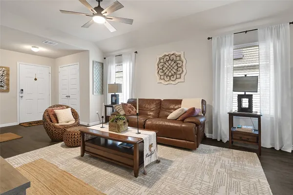 a living room with furniture and wooden floor