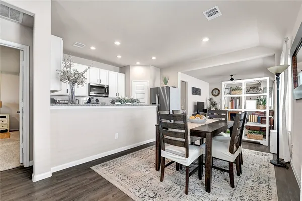 a view of a dining room with furniture and wooden floor