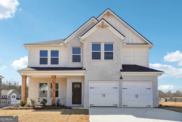 a front view of a house with a garage
