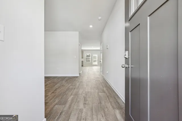 a view of hallway with wooden floor