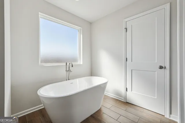a white bath tub sitting in a bathroom