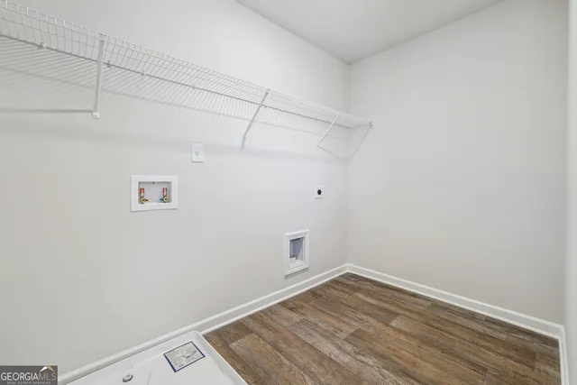 a view of a room with wooden floor