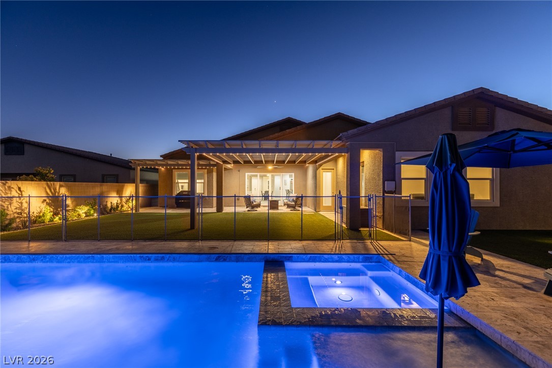 7036 Arabian Ridge Street Las Vegas, NV 89131 - Photo 58 of 64 Sparkling pool and spa with an automated cover, cantilever umbrella, and safety fence.