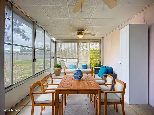 a dining room with furniture a chandelier and wooden floor