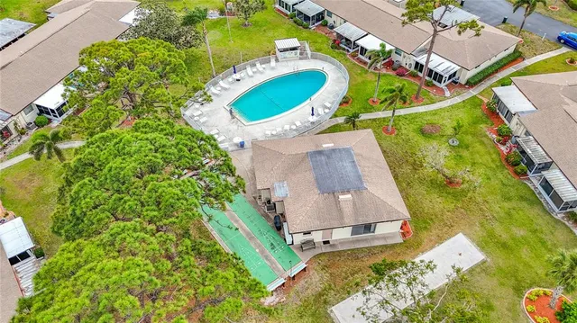 an aerial view of a house with a swimming pool