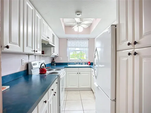 a kitchen with a sink cabinets and window
