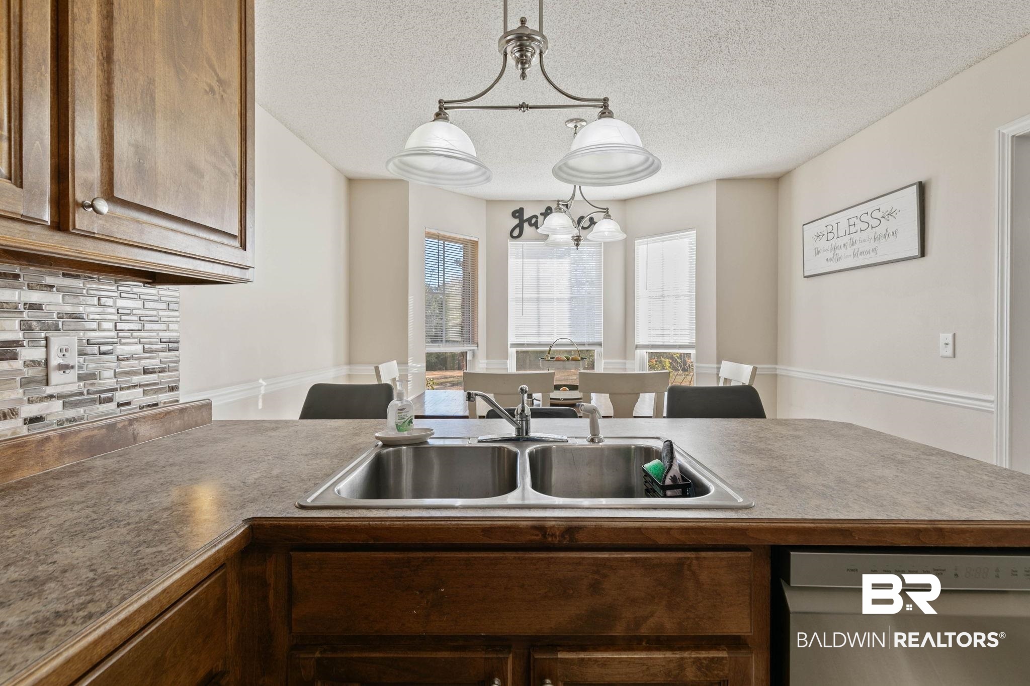 55750 Lottie Road Perdido, AL 36562 - Photo 62 of 84 Kitchen with backsplash, dishwasher, decorative light fixtures, a textured ceiling, and wood finish cabinets