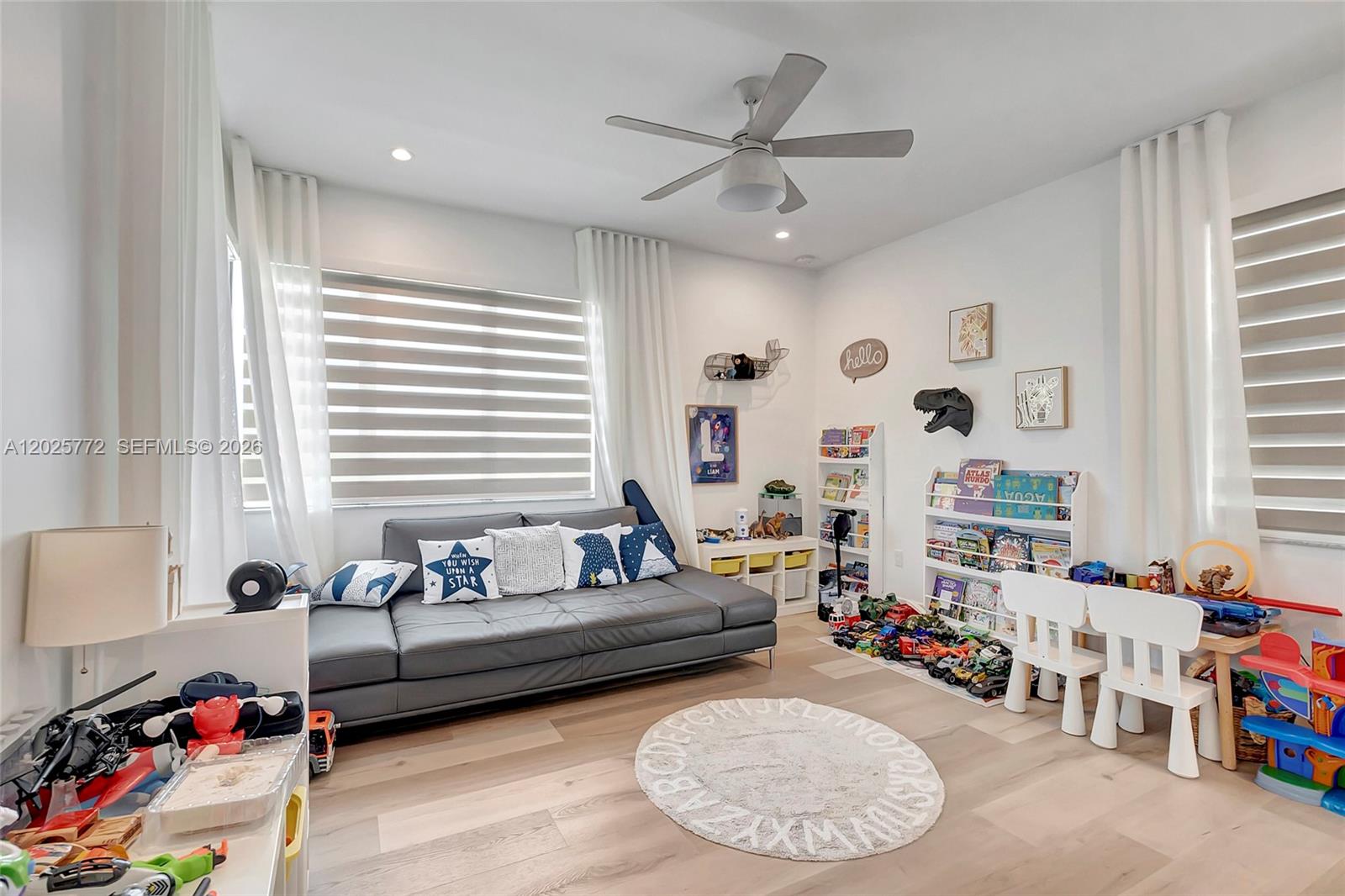 17023 Wandering Wave Avenue Boca Raton, FL 33496 - Photo 52 of 84 a living room with furniture and a large window