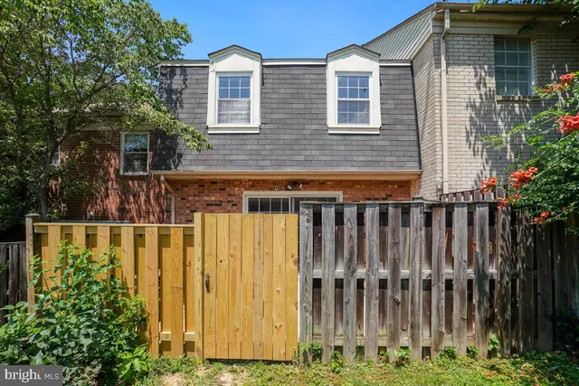 a view of a house with wooden fence