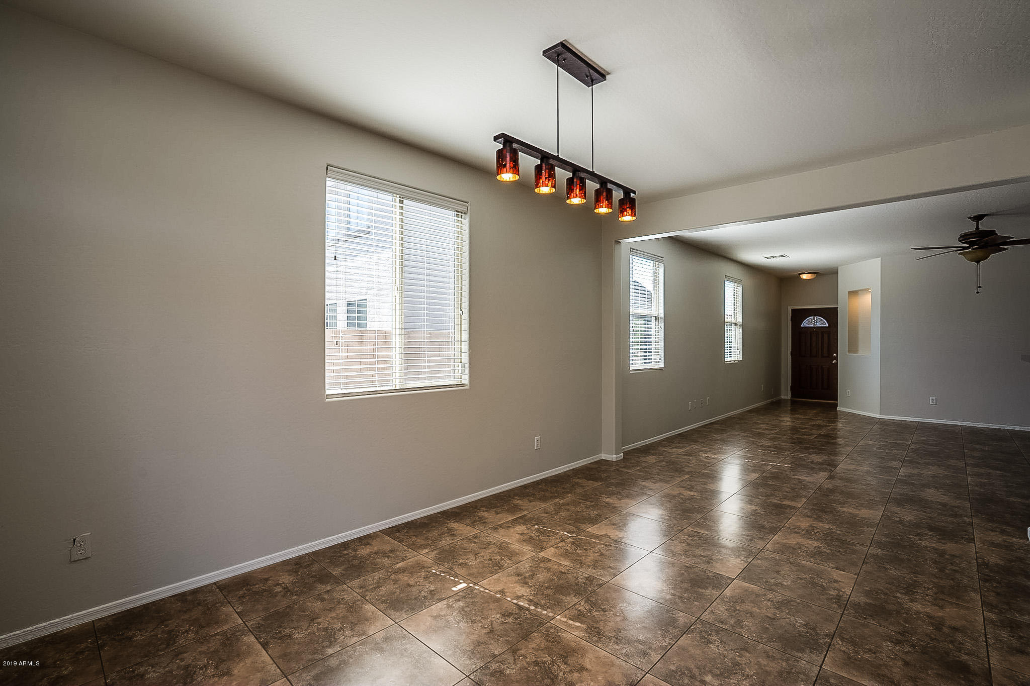 7425 West Darrel Road Laveen, AZ 85339 - Photo 14 of 64 a view of a livingroom with a ceiling fan and window
