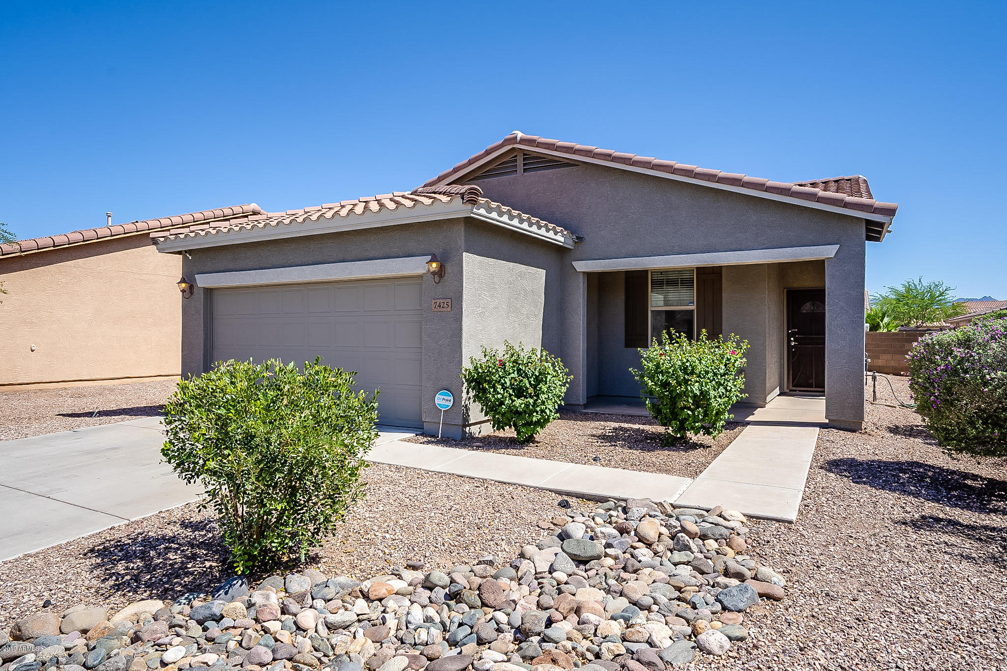 7425 West Darrel Road Laveen, AZ 85339 - Photo 2 of 64 a front view of a house with garden