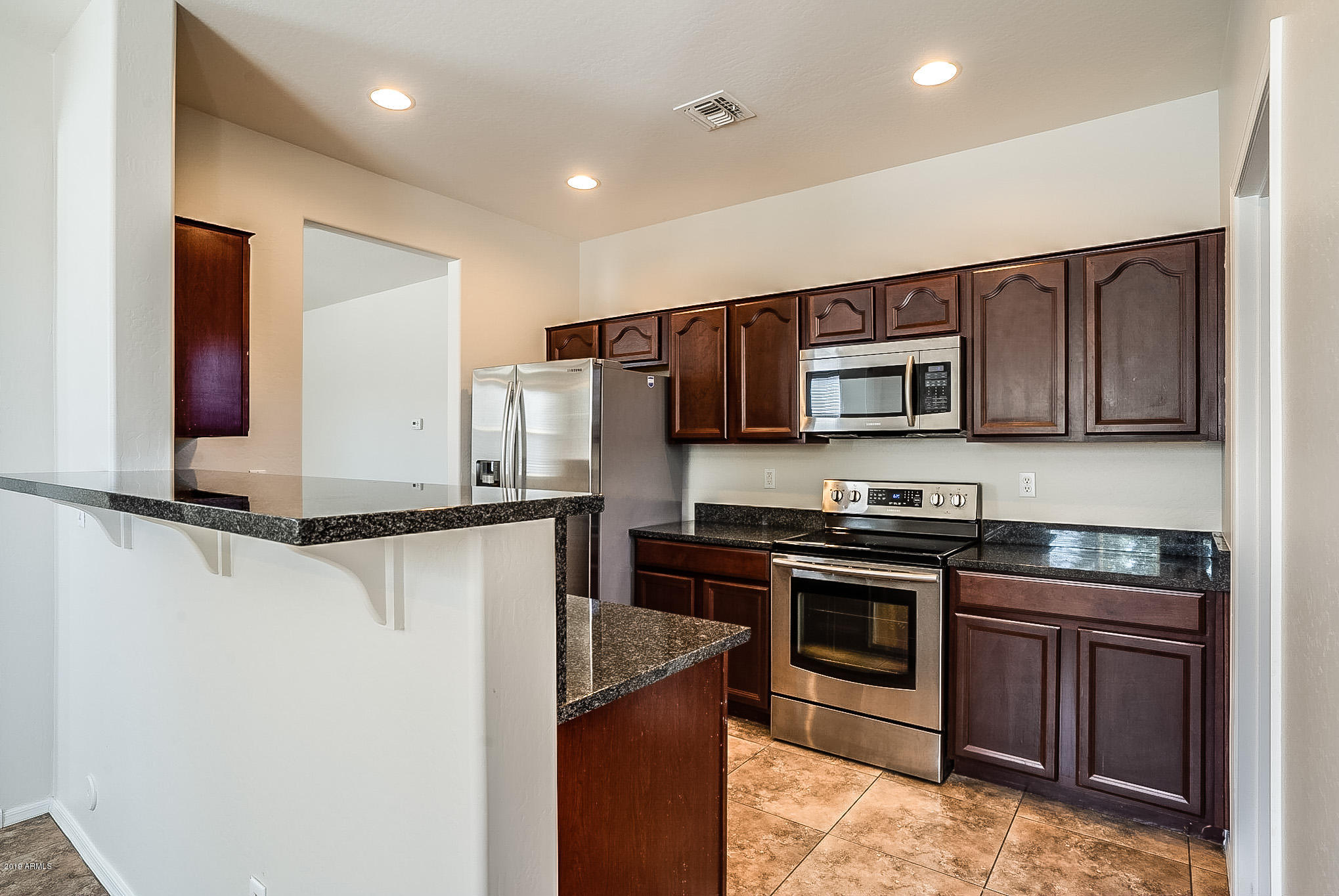 7425 West Darrel Road Laveen, AZ 85339 - Photo 21 of 64 a kitchen with stainless steel appliances granite countertop a stove top oven a sink and dishwasher