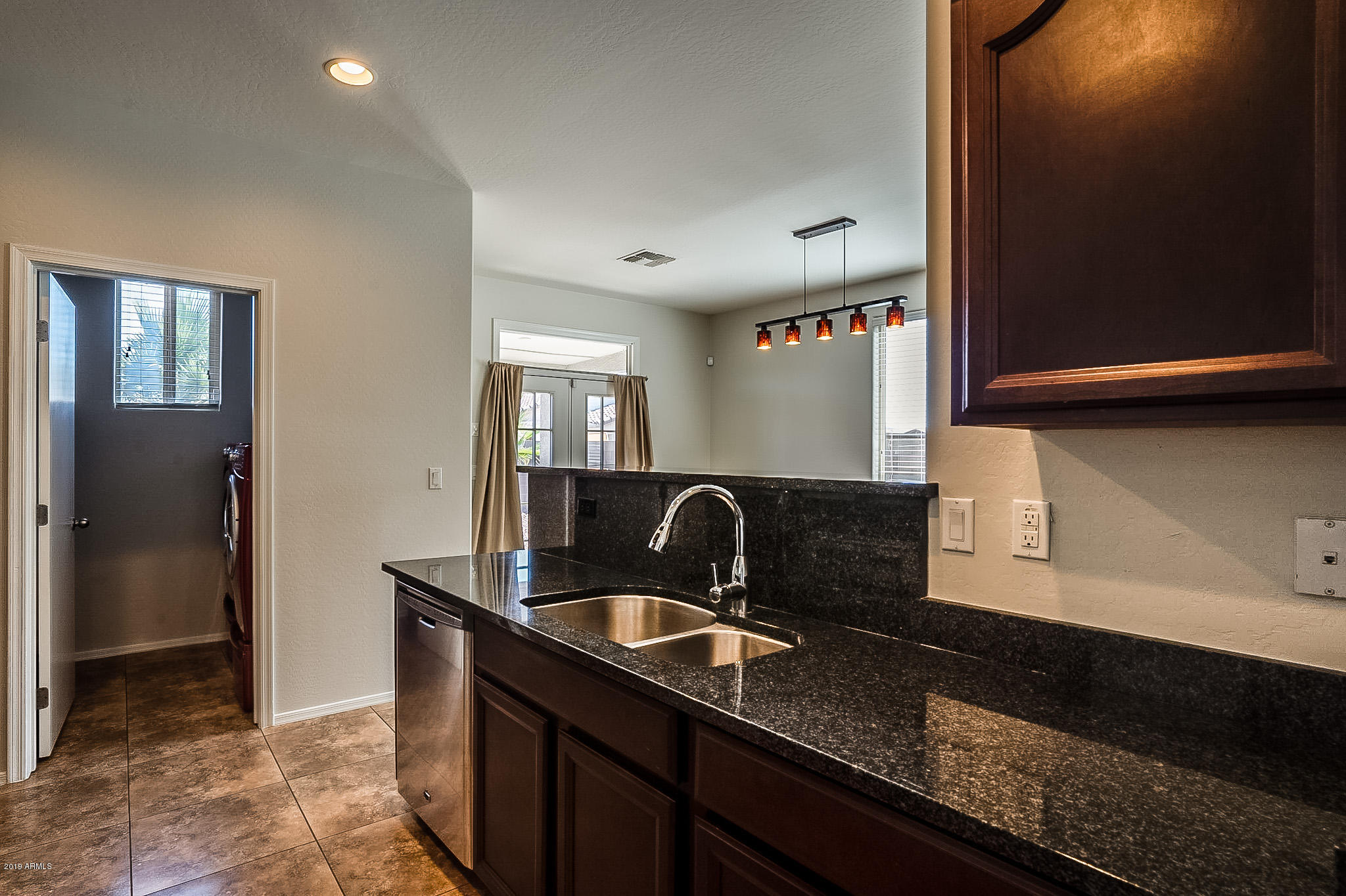 7425 West Darrel Road Laveen, AZ 85339 - Photo 24 of 64 a kitchen with granite countertop a sink and a stove top oven