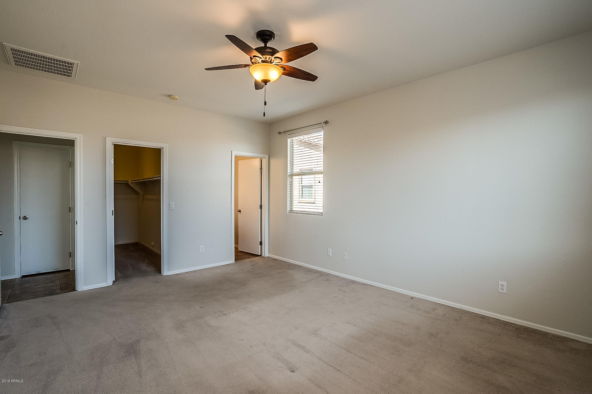 7425 West Darrel Road Laveen, AZ 85339 - Photo 29 of 64 an empty room with a ceiling fan and a window