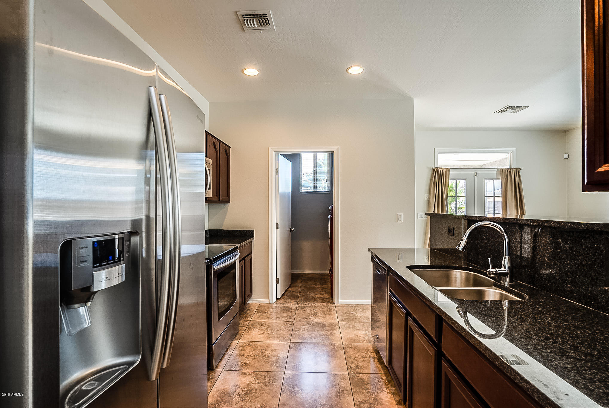 7425 West Darrel Road Laveen, AZ 85339 - Photo 3 of 64 a kitchen with granite countertop a refrigerator and a sink