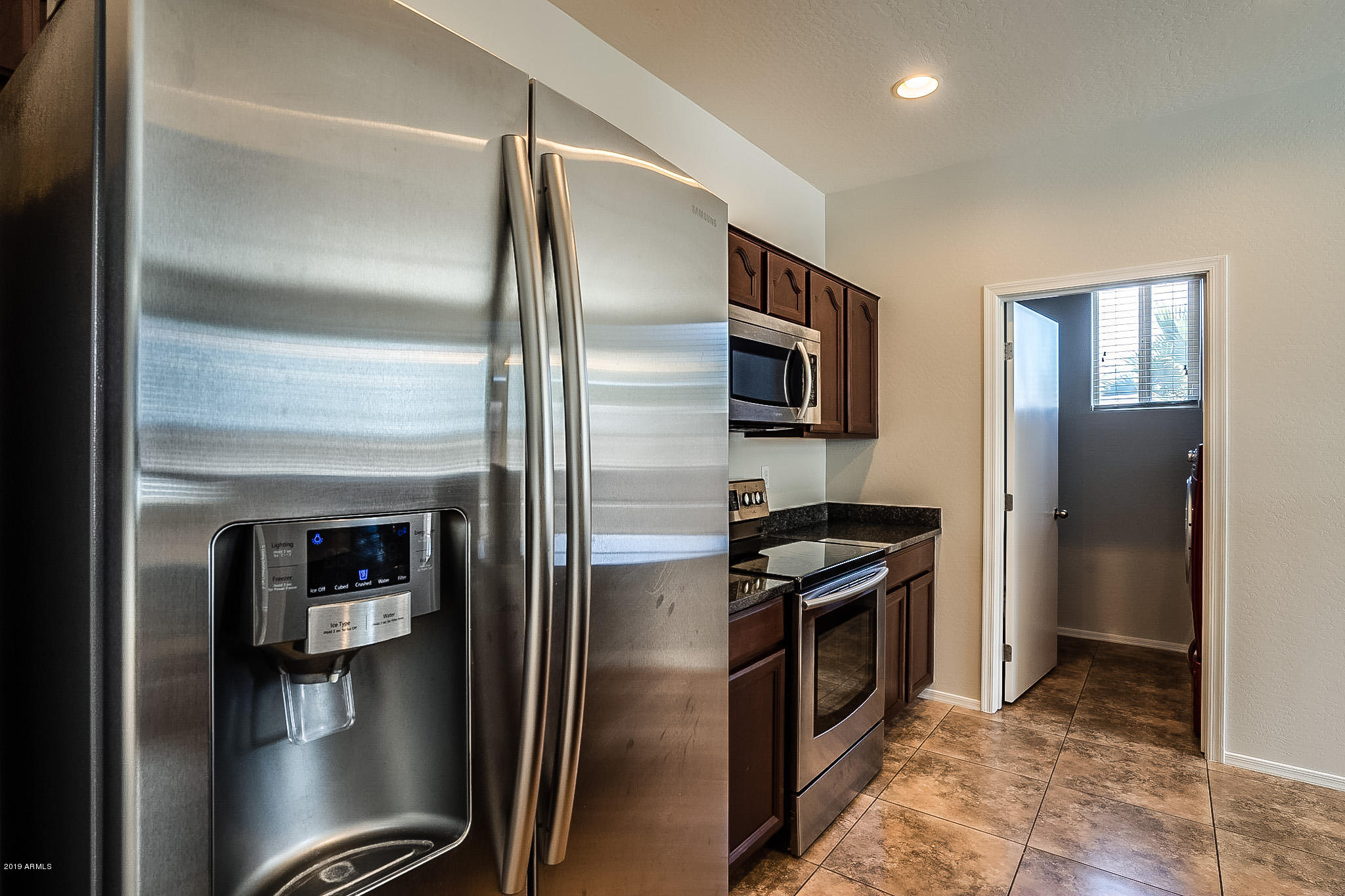 7425 West Darrel Road Laveen, AZ 85339 - Photo 6 of 64 a kitchen with a refrigerator and a stove