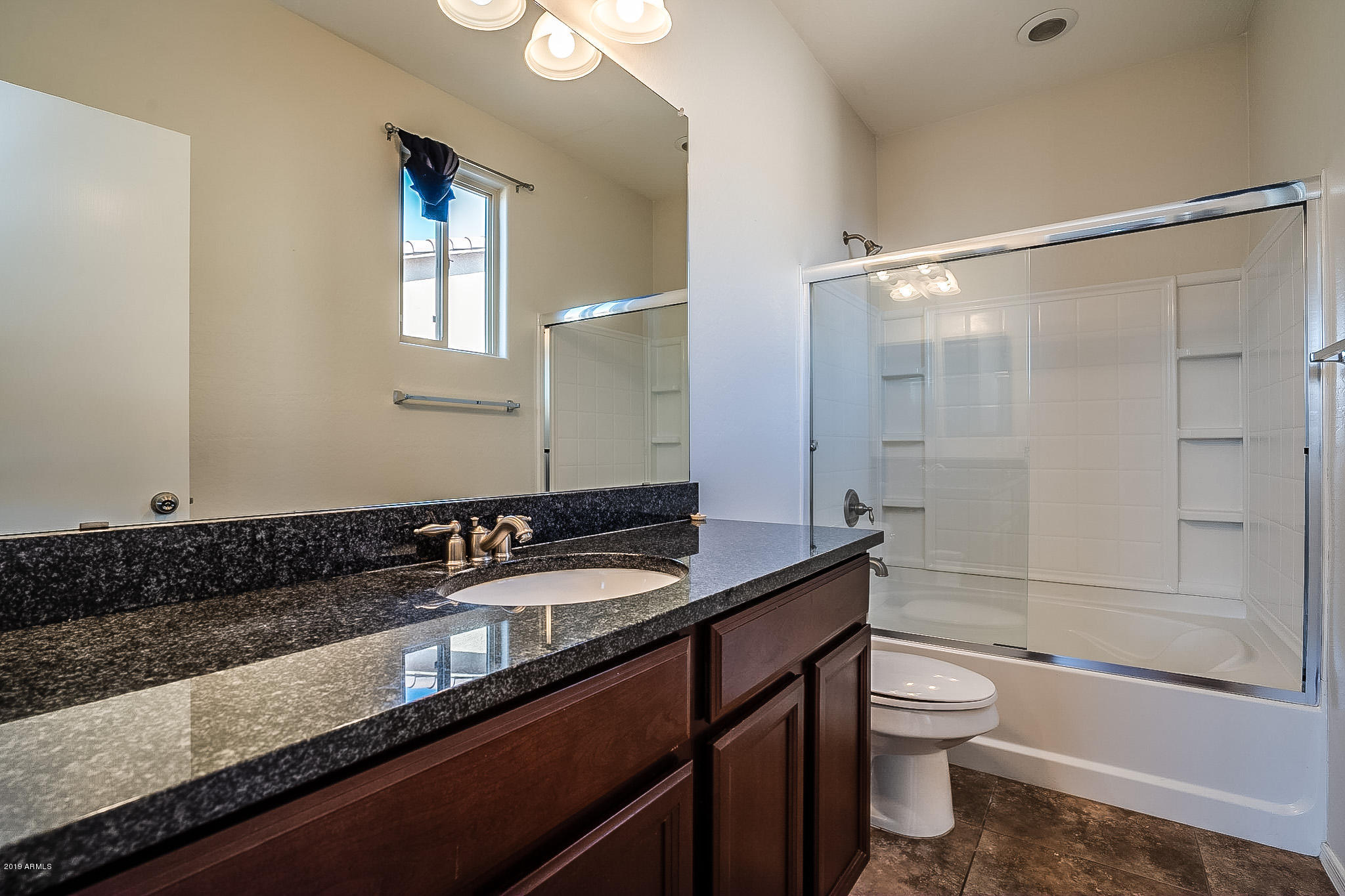 7425 West Darrel Road Laveen, AZ 85339 - Photo 8 of 64 a bathroom with a granite countertop sink toilet and shower