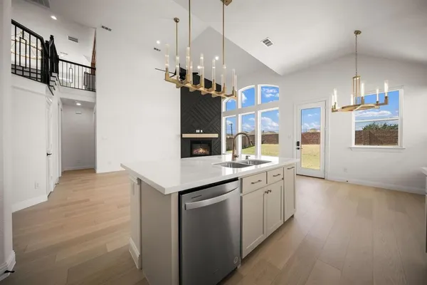 a kitchen with stainless steel appliances granite countertop a sink a stove and a refrigerator