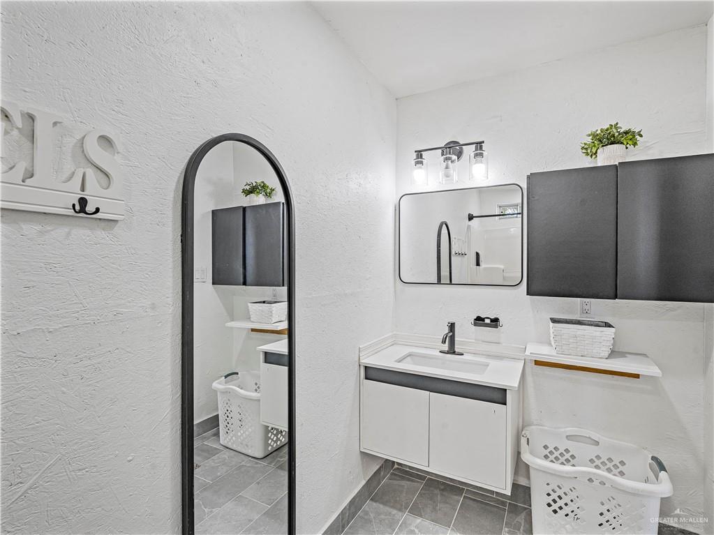 124 Esther Street Edcouch, TX 78538 - Photo 11 of 14 a bathroom with a sink and a mirror