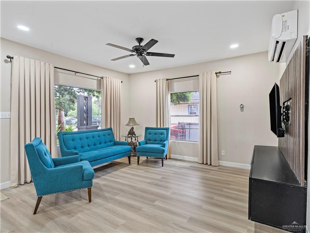 124 Esther Street Edcouch, TX 78538 - Photo 3 of 14 a living room with furniture wooden floor and a large window
