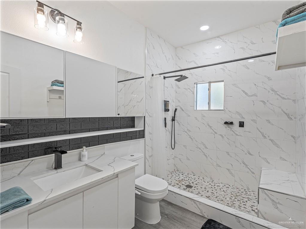 124 Esther Street Edcouch, TX 78538 - Photo 7 of 14 a bathroom with a sink a toilet and shower