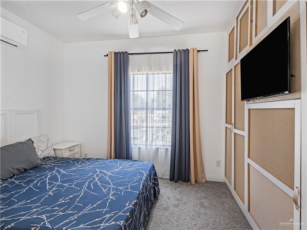 124 Esther Street Edcouch, TX 78538 - Photo 8 of 14 a bedroom with a bed and a flat screen tv