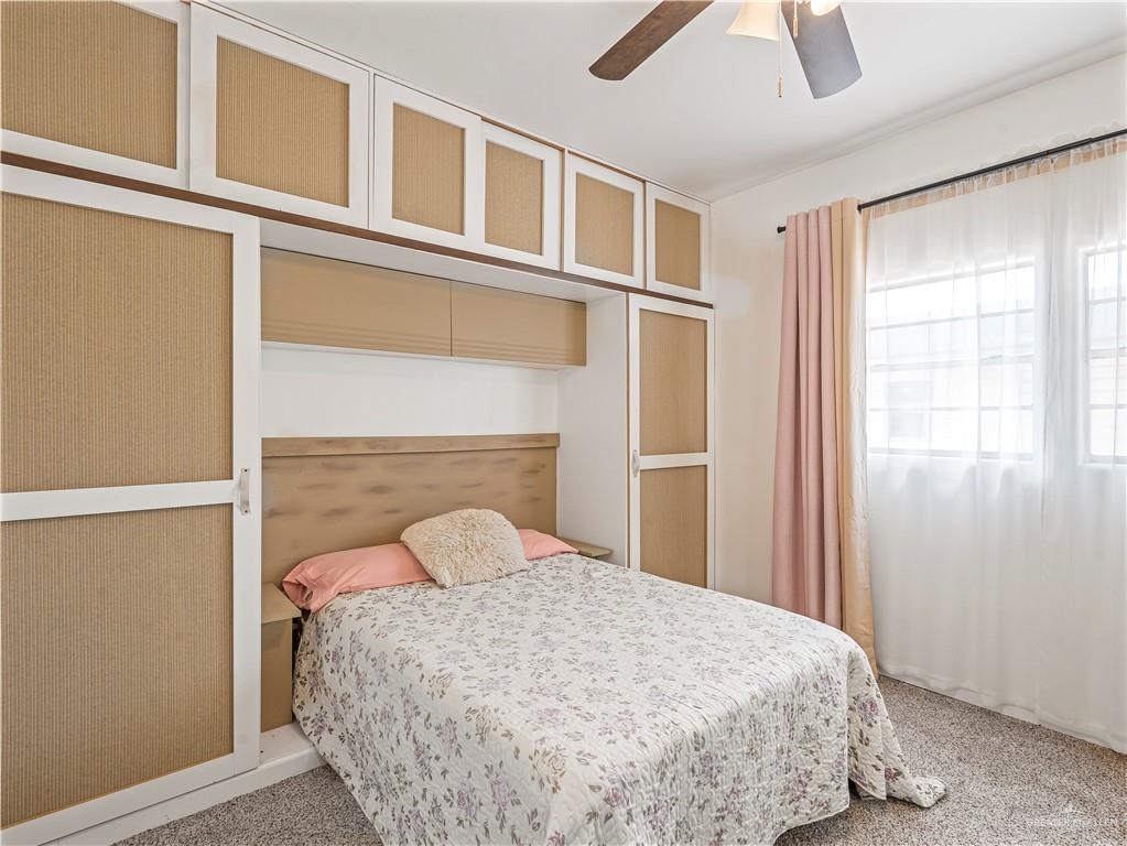 124 Esther Street Edcouch, TX 78538 - Photo 9 of 14 a bedroom with a bed and a window