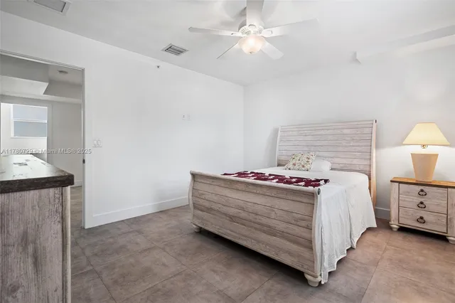 a bed room with a bed and a chandelier