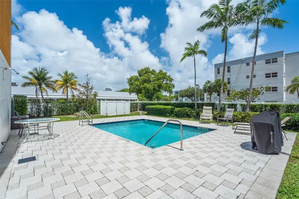a view of a room with a sink and a mirror