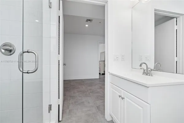 a bathroom with a tub a sink and a shower