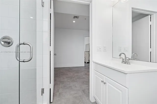 a bathroom with a tub a sink and a shower