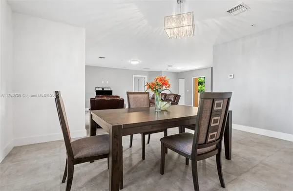 a living room with furniture and kitchen view