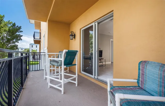 a view of a balcony with table and chairs
