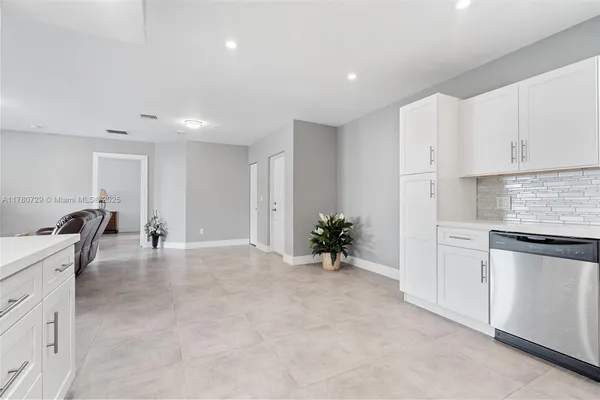 a view of kitchen with sink and refrigerator