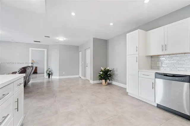 a view of kitchen with sink and refrigerator