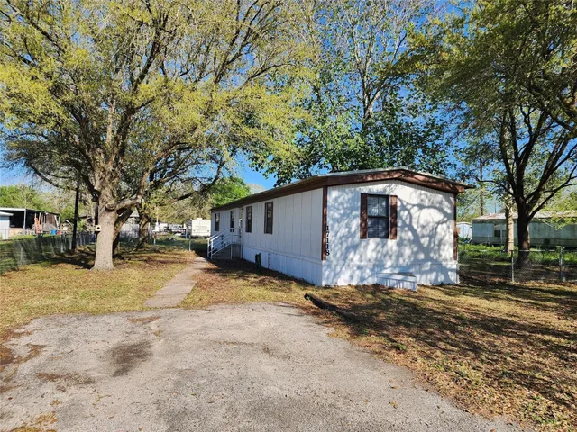 a view of a house with a yard covered in snow