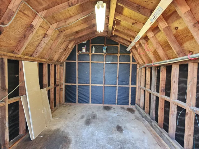 a view of a backyard with plants and a fountain