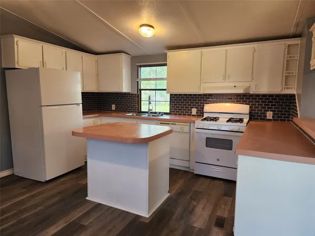 a kitchen with a white cabinets and white appliances