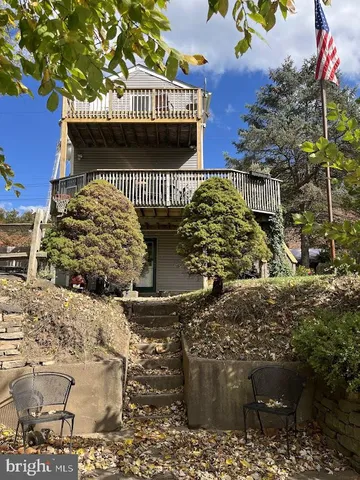 a view of a chairs and table in the roof deck