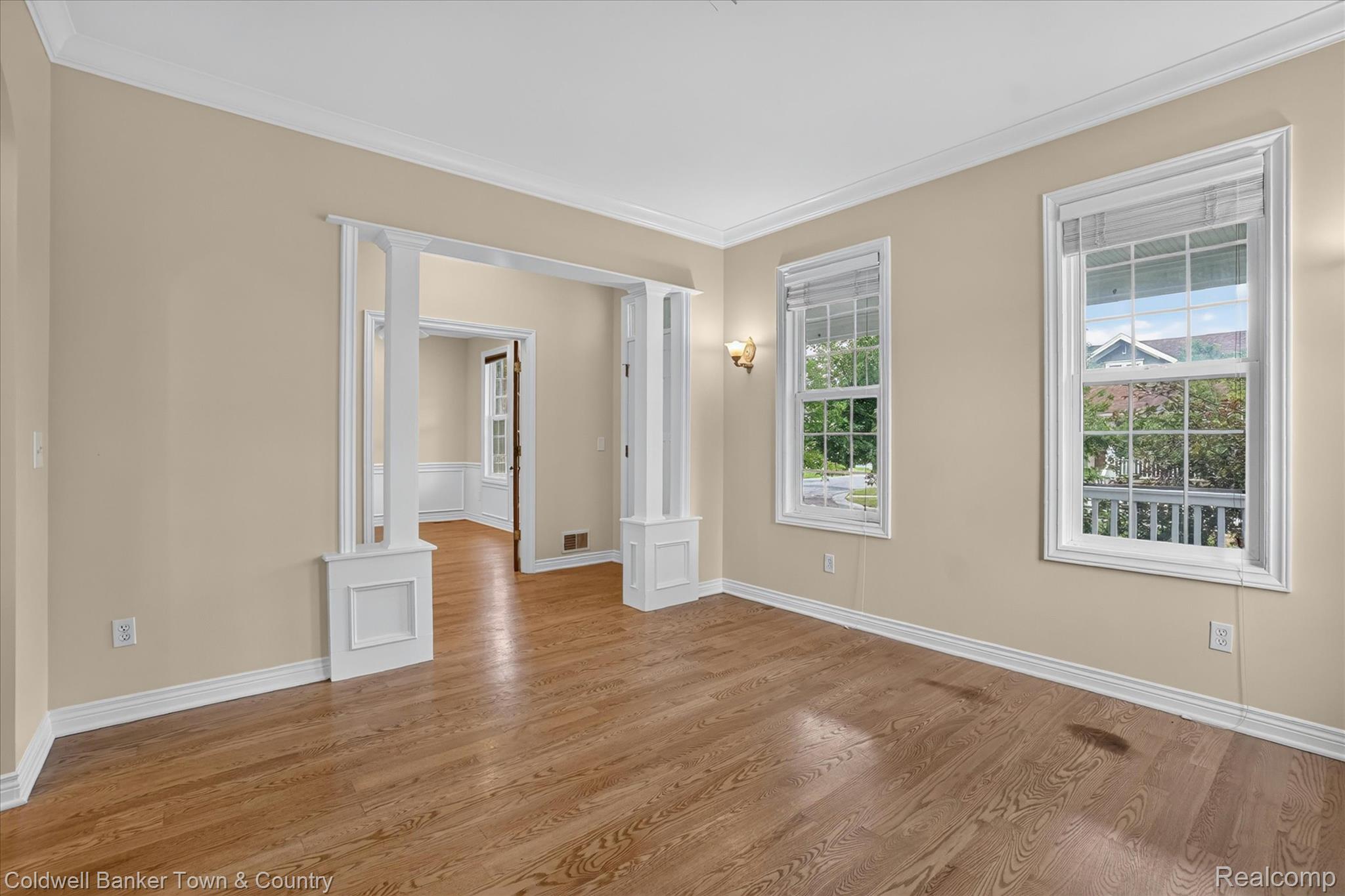 1725 Town Commons Drive Howell, MI 48855 - Photo 13 of 53 Hardwood flooring complemented by tall windows and decorative millwork