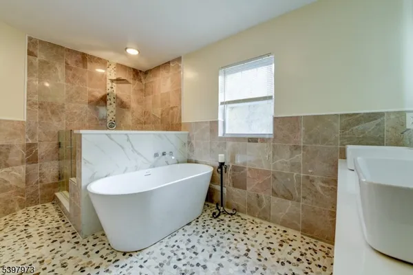 a bathroom with a bathtub and shower