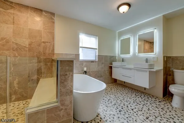 a bathroom with a sink a toilet and bathtub