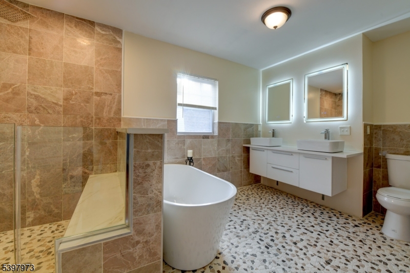 105 Battlehill Avenue Springfield, NJ 07081 - Photo 13 of 22 a bathroom with a sink a toilet and bathtub
