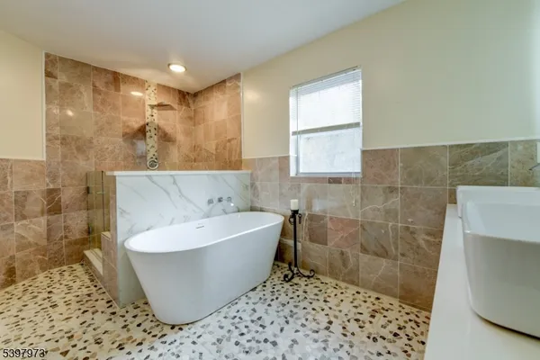 a bathroom with a bathtub and shower