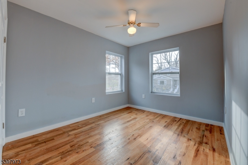 105 Battlehill Avenue Springfield, NJ 07081 - Photo 21 of 22 wooden floor in an empty room with a window