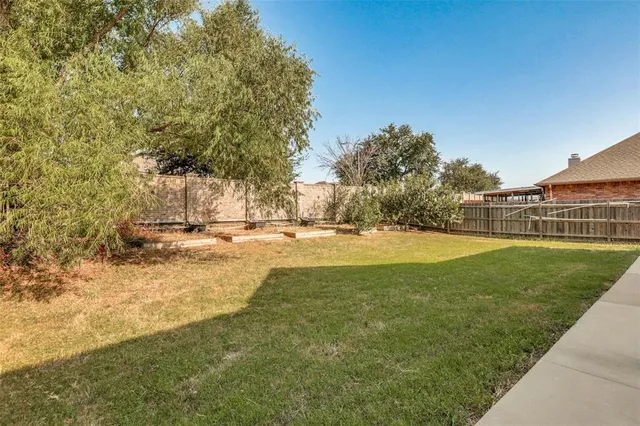 a view of yard with swimming pool and green space