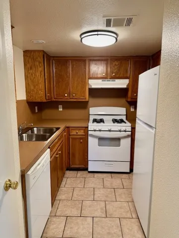a kitchen with a stove cabinets and a refrigerator