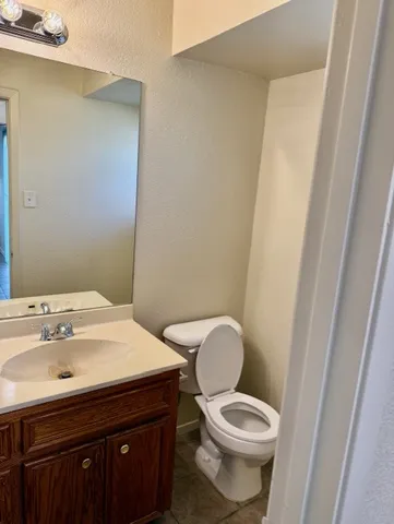 a bathroom with a sink a toilet and vanity